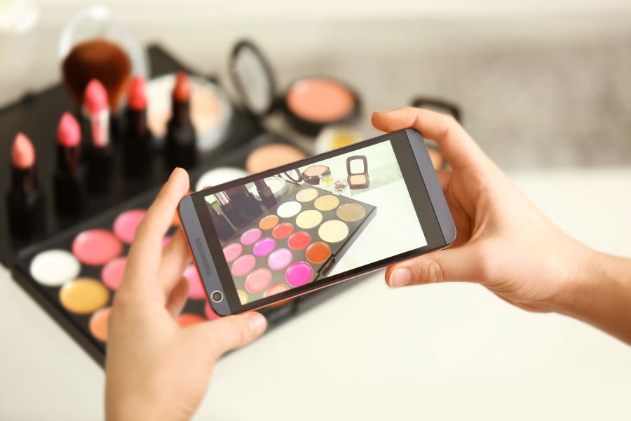 A woman taking product photos with her smartphone