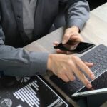 A businessman using a virtual terminal on a laptop to accept payments