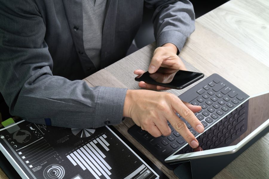 A businessman using a virtual terminal on a laptop to accept payments