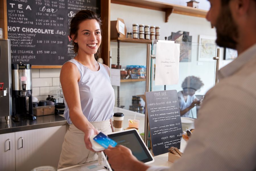 A customer making payment on a Chip and Pin device.