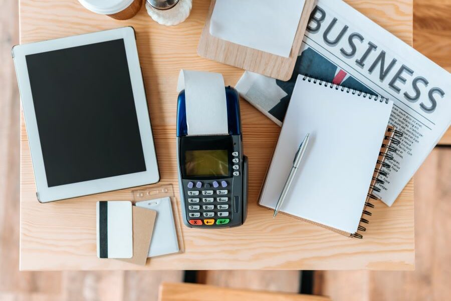 IPad, card reader and credit cards on the businessman's desk