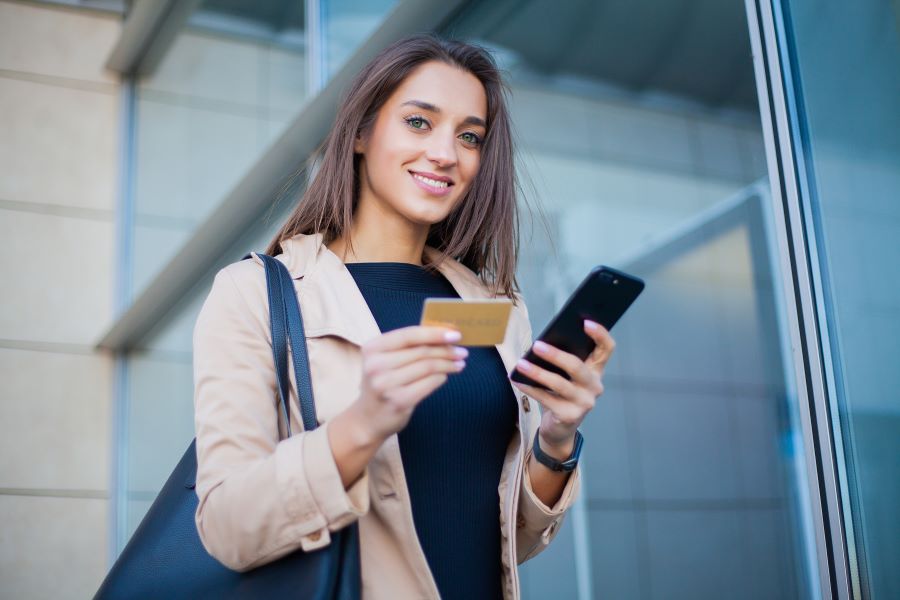 Young woman making credit card payments over the phone