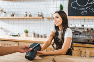 Cashier accepting payment made with a smartphone