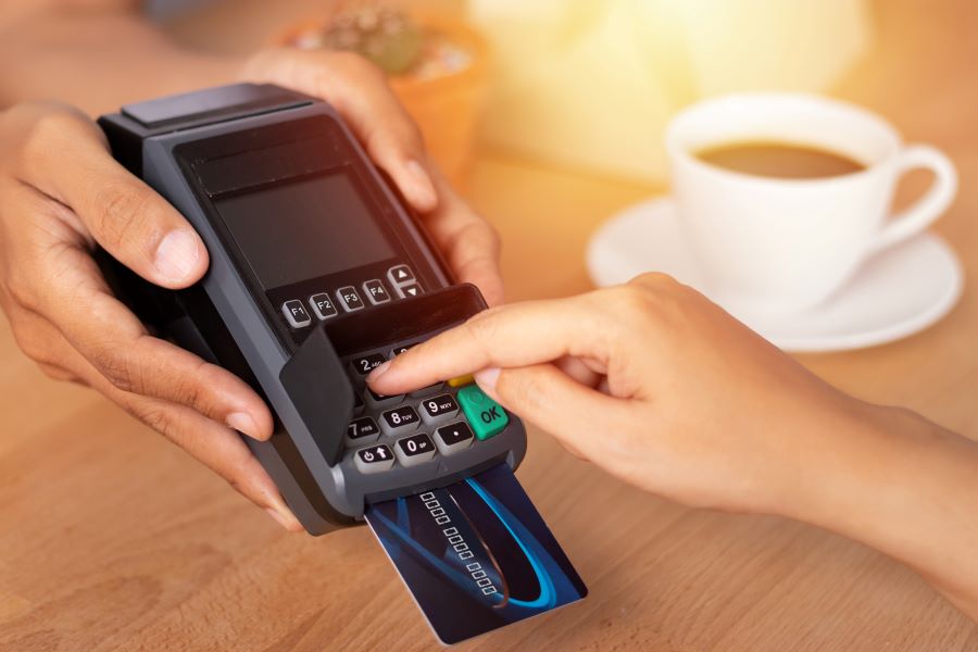 A customer inserts the PIN on the Chip and PIN card machine.