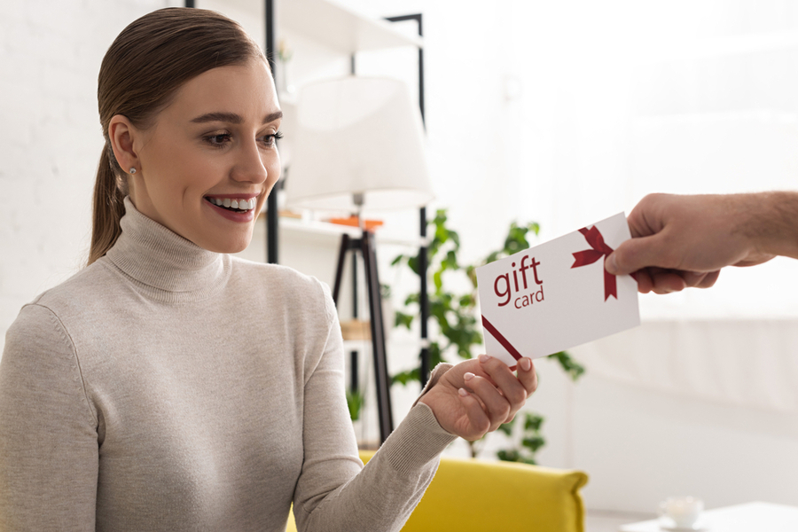 Happy woman receiving a Gift card