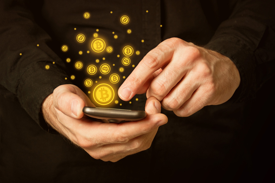 Businessman accepting Bitcoin payment on his smartphone