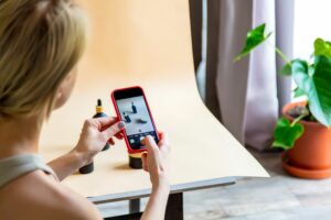 A woman taking photos with her smartphone for e-commerce