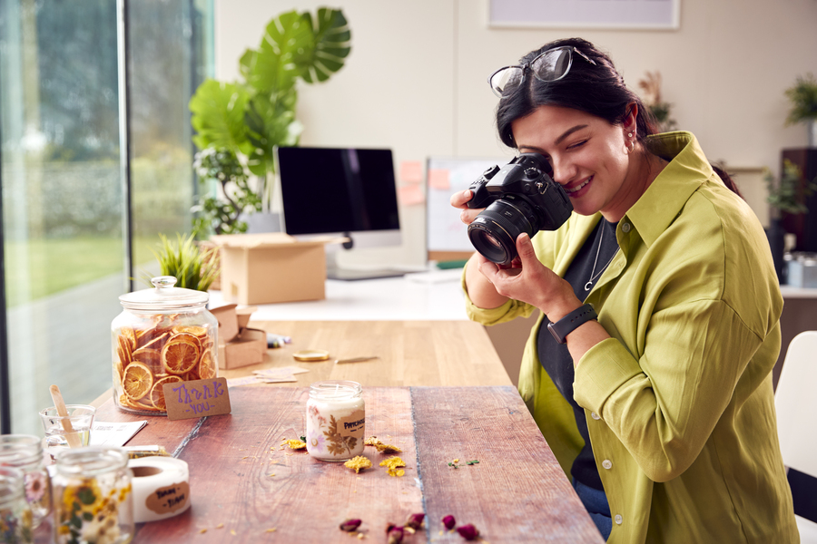 A woman taking product photos for her small business