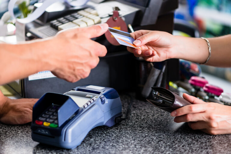 A customer paying with a credit card at a credit card terminal.