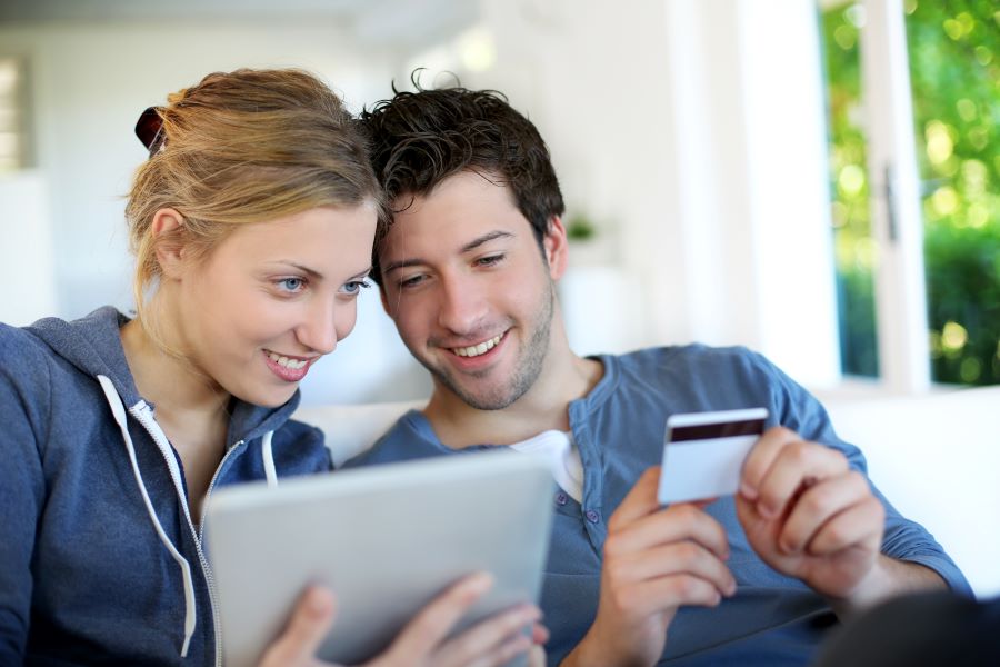 Happy couple paying with the buy now pay later option online