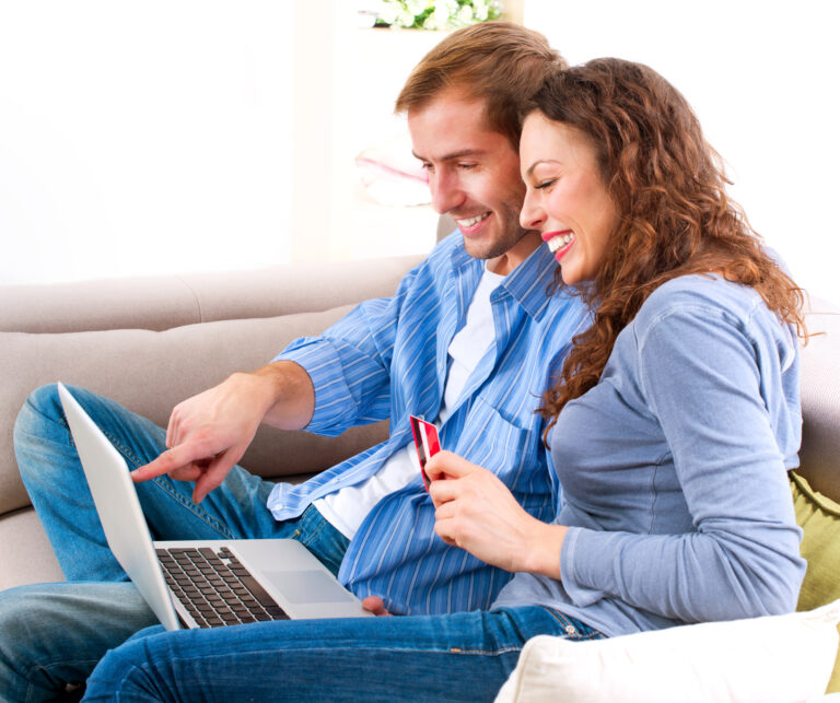 happy couple making an online order on their laptop