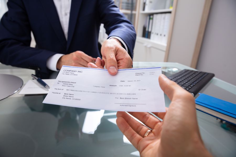 A businessman paying with a cheque