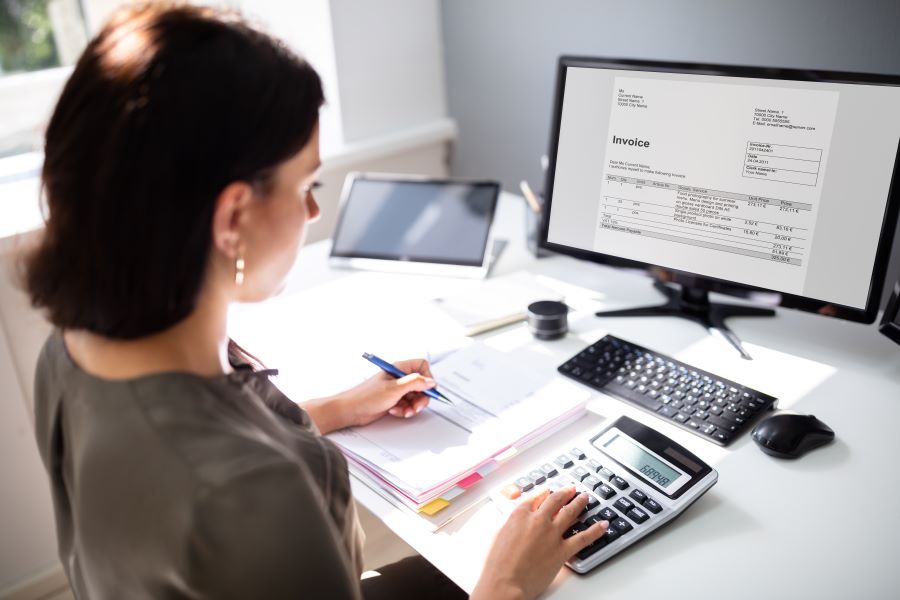 A businesswoman making a proforma invoice on a computer