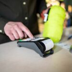 Salesman with a payment terminal and a paper receipt