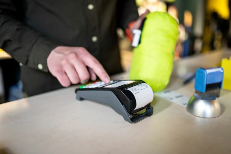 Salesman with a payment terminal and a paper receipt