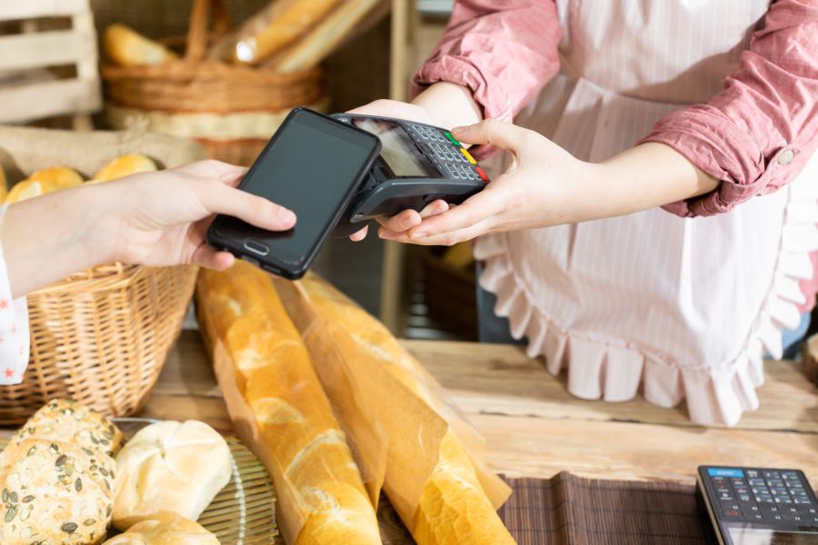 A small businessman using a Paymentsense credit card reader