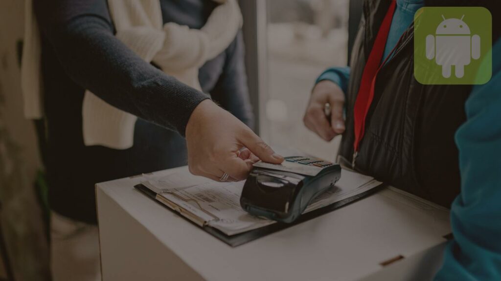 A Person in Black Long Sleeves Tapping the Credit Card on a POS Terminal