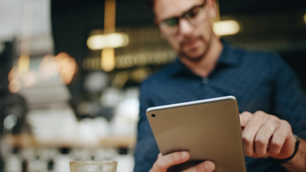 Entrepreneur Using a Tablet Computer Sitting in a Restaurant