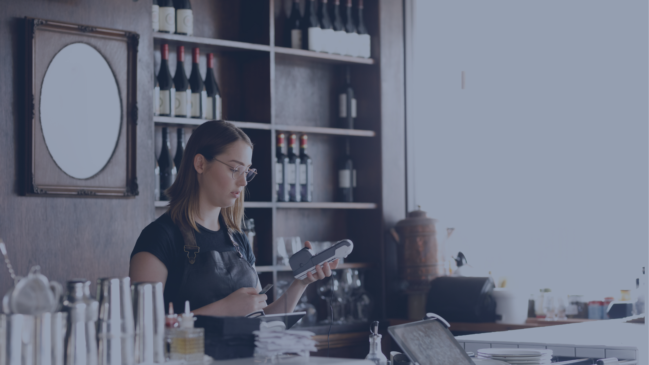 Female Cafe Worker Accepting Payment With Contactless POS machine