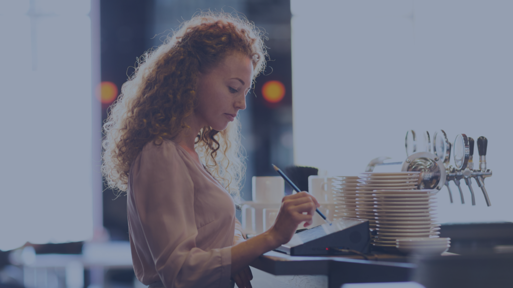 Pensive waitress adding order in restaurant POS