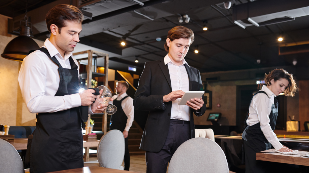 Concentrated restaurant manager checking online records on table